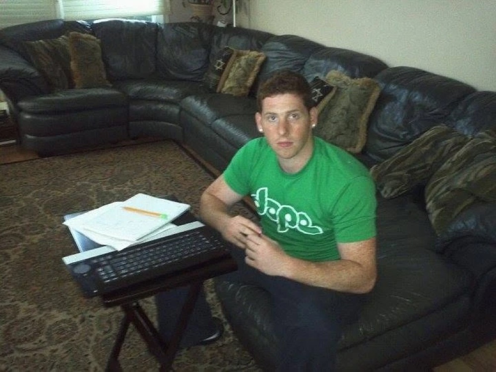 Julian working from a folding tray table at home